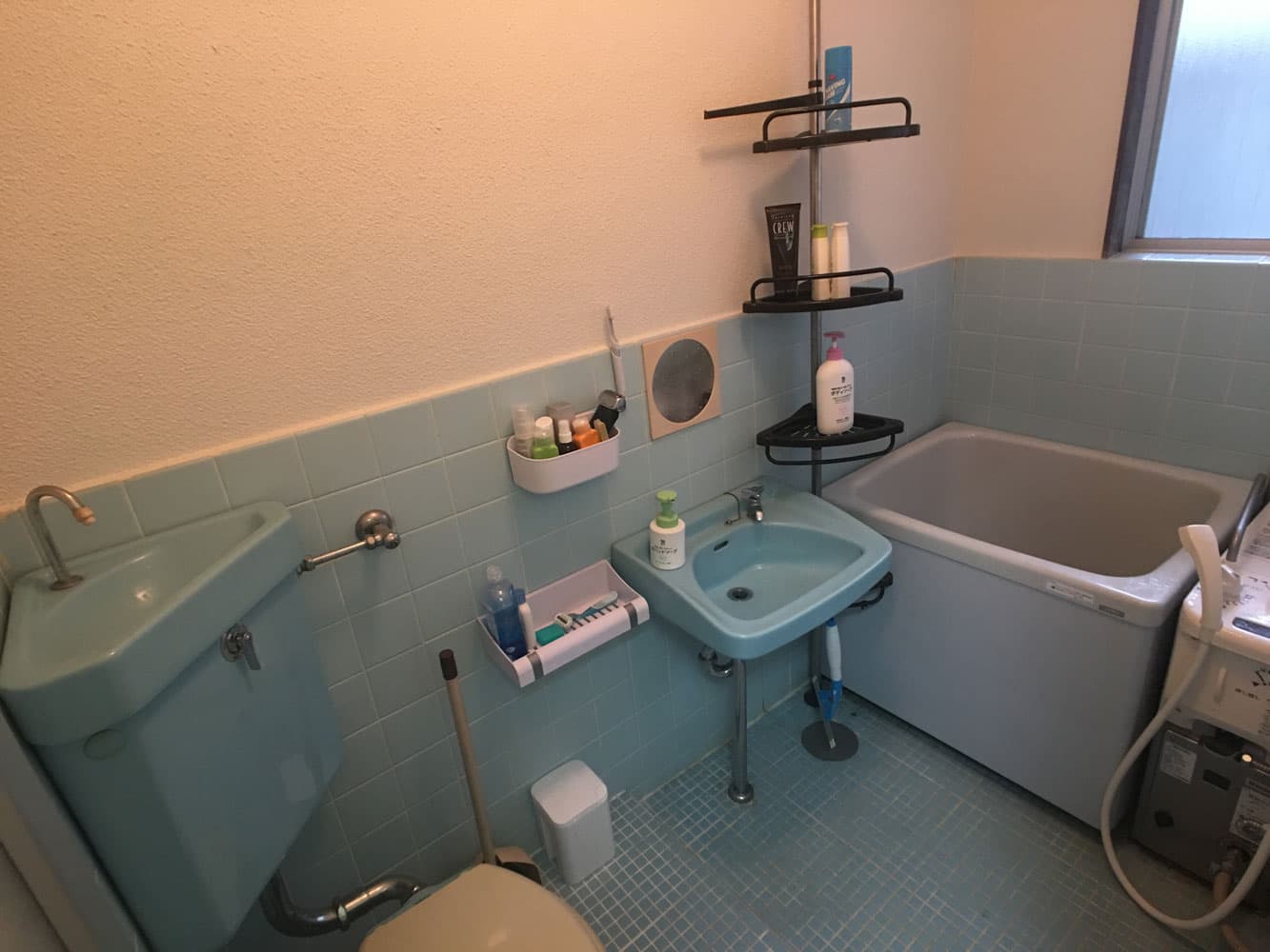 The bathroom in Mitaka House apartments, containing a Japanese-style bath and toilet in the same room.
