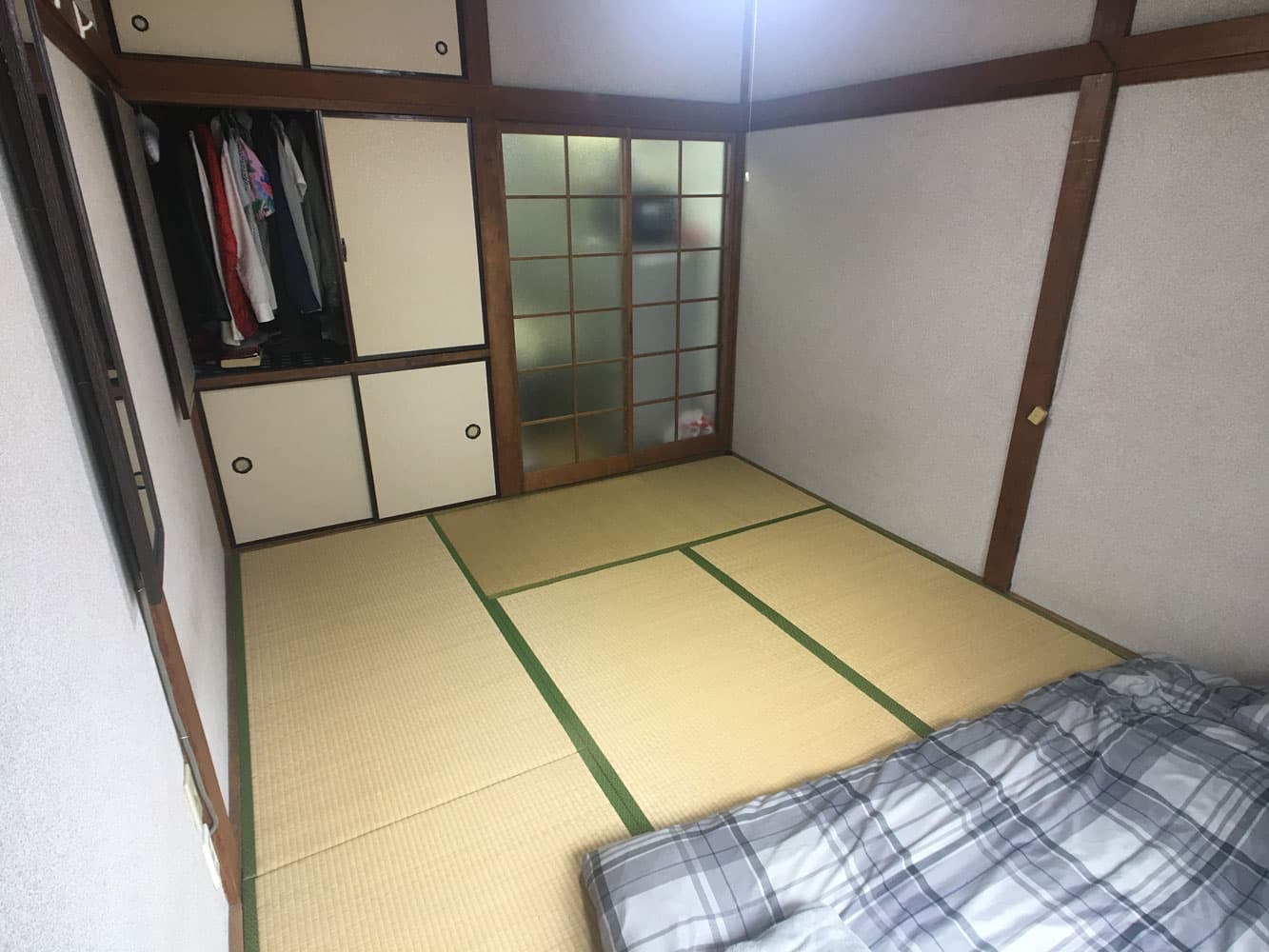 The traditional Japanese bedroom at Mitaka House, with tatami flooring and storage cabinets.